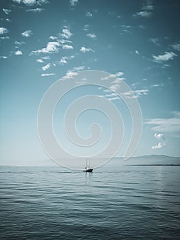 Vertical shot of a little boat at Lake Geneva in Nyon, Geneva, Switzerland