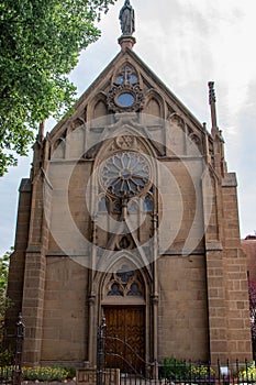 Vertical shot of the Loretto Chapel in Santa Fe, New Mexico with elegant gothic arches and windows