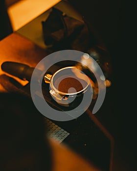 Vertical shot of a machine scooper with flattened coffee