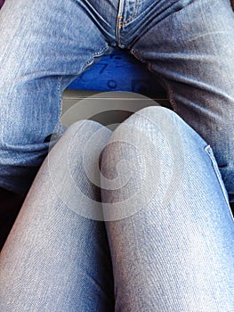 Vertical shot of a male and a female legs wearing tight jeans