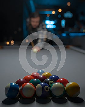 Vertical shot of a male preparing to start a game of pool