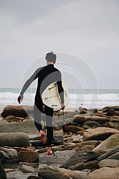 Vertical shot of a man doing surfing processed with VSCO