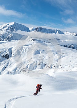 Vertical shot of a man snowboarding in snowy mountains