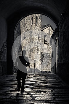 Vertical shot of a man on the street in Casco Antiguo, Caceres, Extremadura, Spain photo