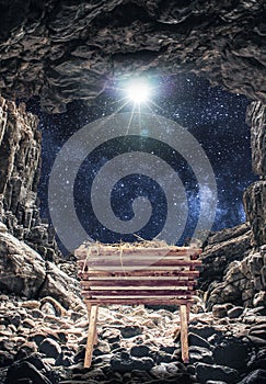 Vertical shot of a manger in a cave under a bright starry sky during the birth of Jesus Christ