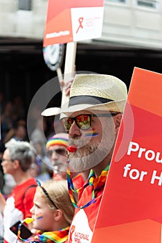 Vertical shot of a marcher representing the National Aids Trust on the street