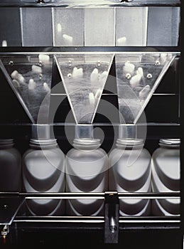 Vertical shot of medicine processing in the equipment of a pharmaceutical factory