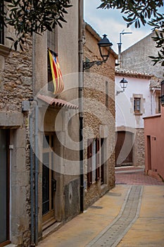 Vertical shot of the medieval narrow road in between buildings the city of Begur in Spain