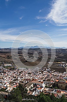 Vertical shot of modern buildings near the mountains in Espera, Spain photo
