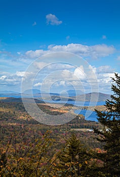 Vertical shot of Moosehead lake with early fall foliage. Maine, United States.