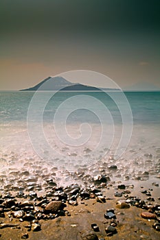 Vertical shot of Mount Krakatoa in Indonesia near the Acid lake covered in fog