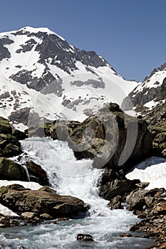Vertical shot of the mountain river in Susten pass located in Switzerland in winter during daylight