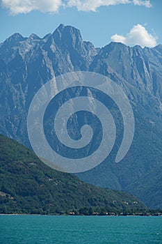 Vertical shot of mountains around Lake Como under on a sunny day in Lombardy region, Italy