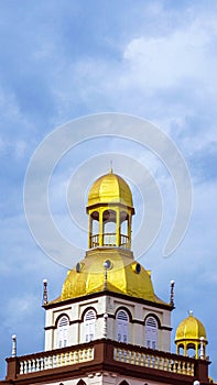 Vertical shot of Muhammadi Mosque dome against blue sky in Kota Bharu, Malaysia photo