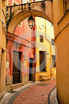 Vertical shot of the narrow alley and buildings captured in Menton, French Riviera, France