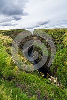 Vertical shot of a narrow gorge at Duncansby Head near John o\'Groats in Caithness, Scotland