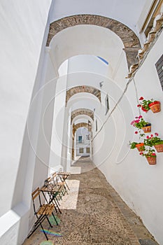 Vertical shot of narrow arcaded street in Vejer de la Frontera o photo