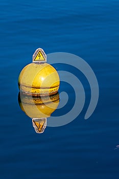 Vertical shot of a nautical buoy floating in the water of Lake Geneva in Switzerland