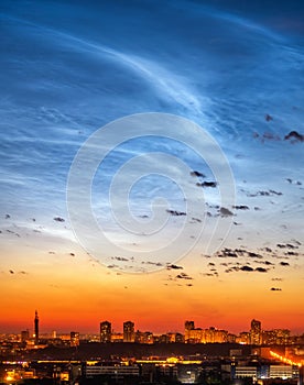 Vertical shot of noctilucent clouds over Yekaterinburg city downtown at summer night