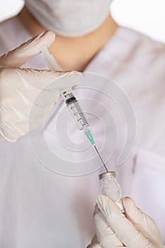 Vertical shot o a doctor holding a vaccine - the concept of corona virus