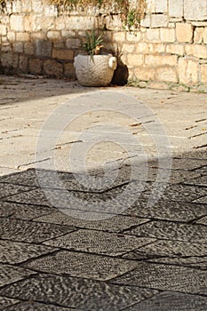 Vertical shot of an old clay flowerpot against a brick wall in Slovakia