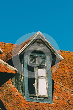 Vertical shot of an old dormer on the roof of a building