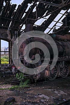 Vertical shot of an old locomotive in an old train yard captured in Lebanon