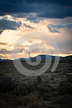 Vertical shot of an old metal farm windmill against scenic sunset in South Africa