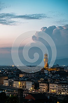 Vertical shot of Old Palace in Florence City Hall tower architect Arnolfo di Cambio in evening lights on warm summer photo