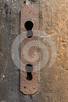 Vertical shot of an old rusted keyholes
