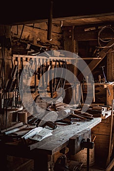 Vertical shot of old tools of carpenter workshop on wooden table