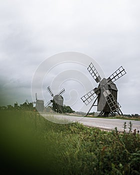 Vertical shot old wooden windmills in the Oland Island in Lerkaka, Sweden