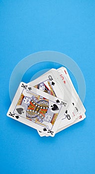 Vertical shot of a pack of playing cards isolated on a blue background