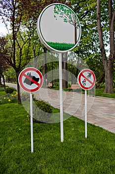 Vertical shot of park prohibitive and declarative signs placed in the park photo