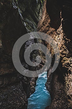 Vertical shot of the Partnach Gorge in Germany formed from a chinked mountain