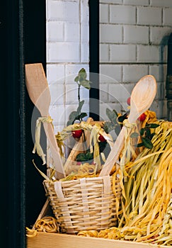 Vertical shot of pasta with wooden spoons in a basket