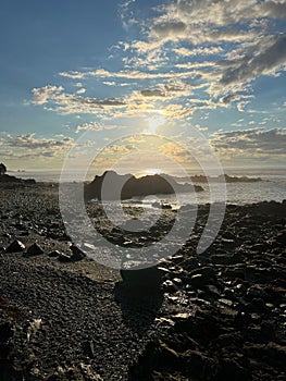 Vertical shot of a peaceful rocky shore at sunrise in Lubec, Maine, USA