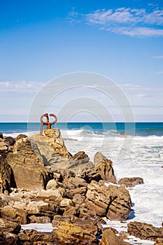 Vertical shot of the Peine del Viento sculptures of Eduardo Chillida at the beach in Spain photo