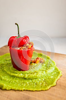 Vertical shot of a pepper stuffed with soybeans and pureed peas