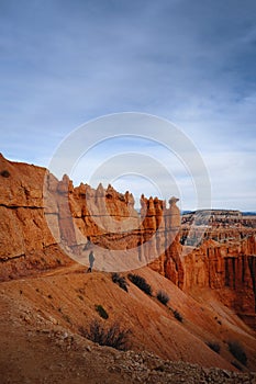 Vertical shot of a person standing on mountain in Bryce Canyon National Park, Utah, USA