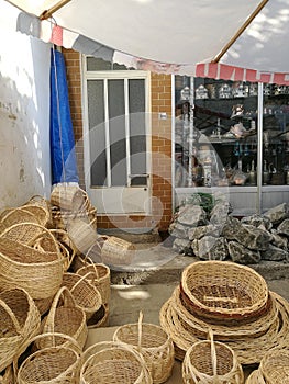 Vertical shot of picnic baskets of various shapes and sizes in front of a house