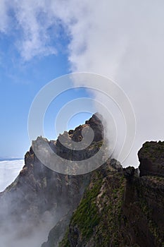 Vertical shot of the Pico do Arieiro in the clouds, Madeira, Portugal photo