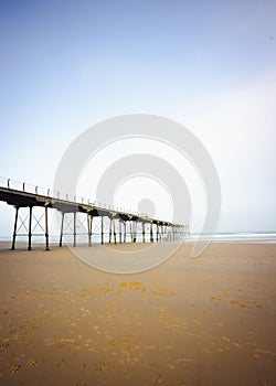 Vertical shot of the pier at the North Yorkshire seaside town of Saltburn-by-the-Sea on a misty day