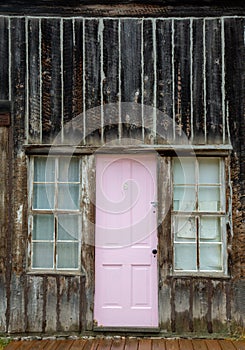 Vertical shot of a pink door of an old wooden house in a ghost town in Colorado, USA
