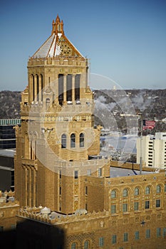 Vertical shot of the Plummer Building surrounded by the snow and ills in Rochester, Minnesota