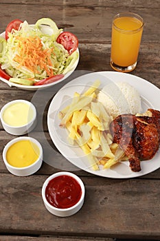 Vertical shot of pollo a la brasa Peruvian dish in a restaurant photo