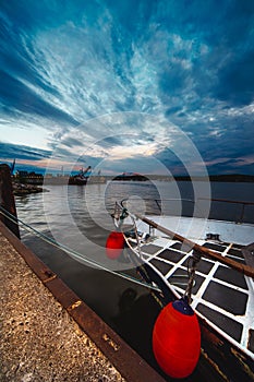 Vertical shot of the port aquatory and a dock at sunset. Klaipeda, Lithuania photo
