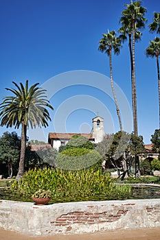 Vertical Shot of a Pound and palm trees in the Court Yard in a Historic Spanish Mission Church in California