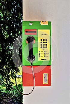 Vertical shot of a public payphone on a white wall