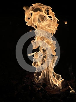 Vertical shot of a raging fire on a black background